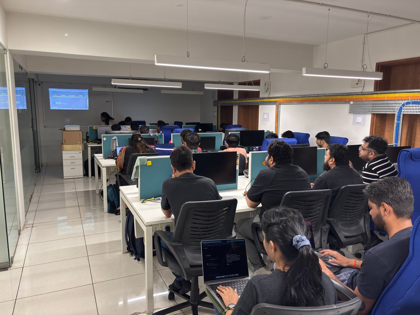 Developers participating in a hands-on community workshop with laptops