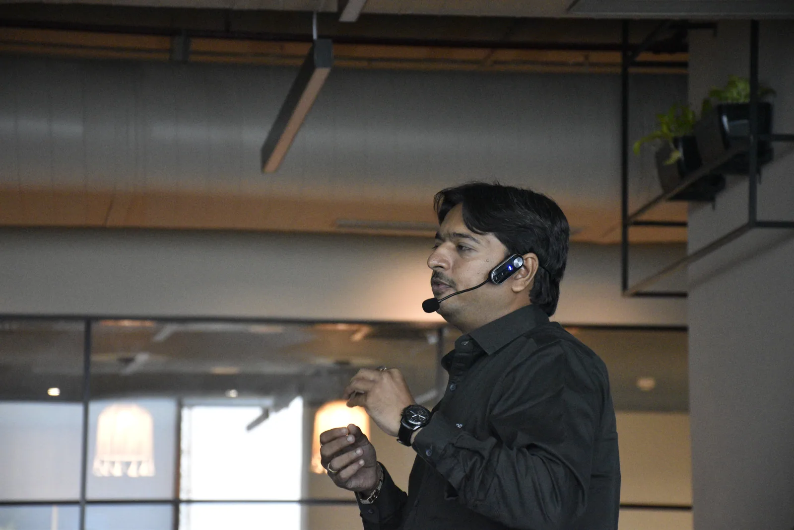 Jaydeep Adesara speaking with a headset microphone during a technical session