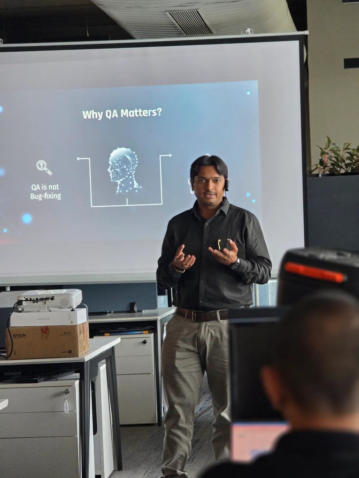Jaydeep Adesara presenting a session about why software quality assurance matters