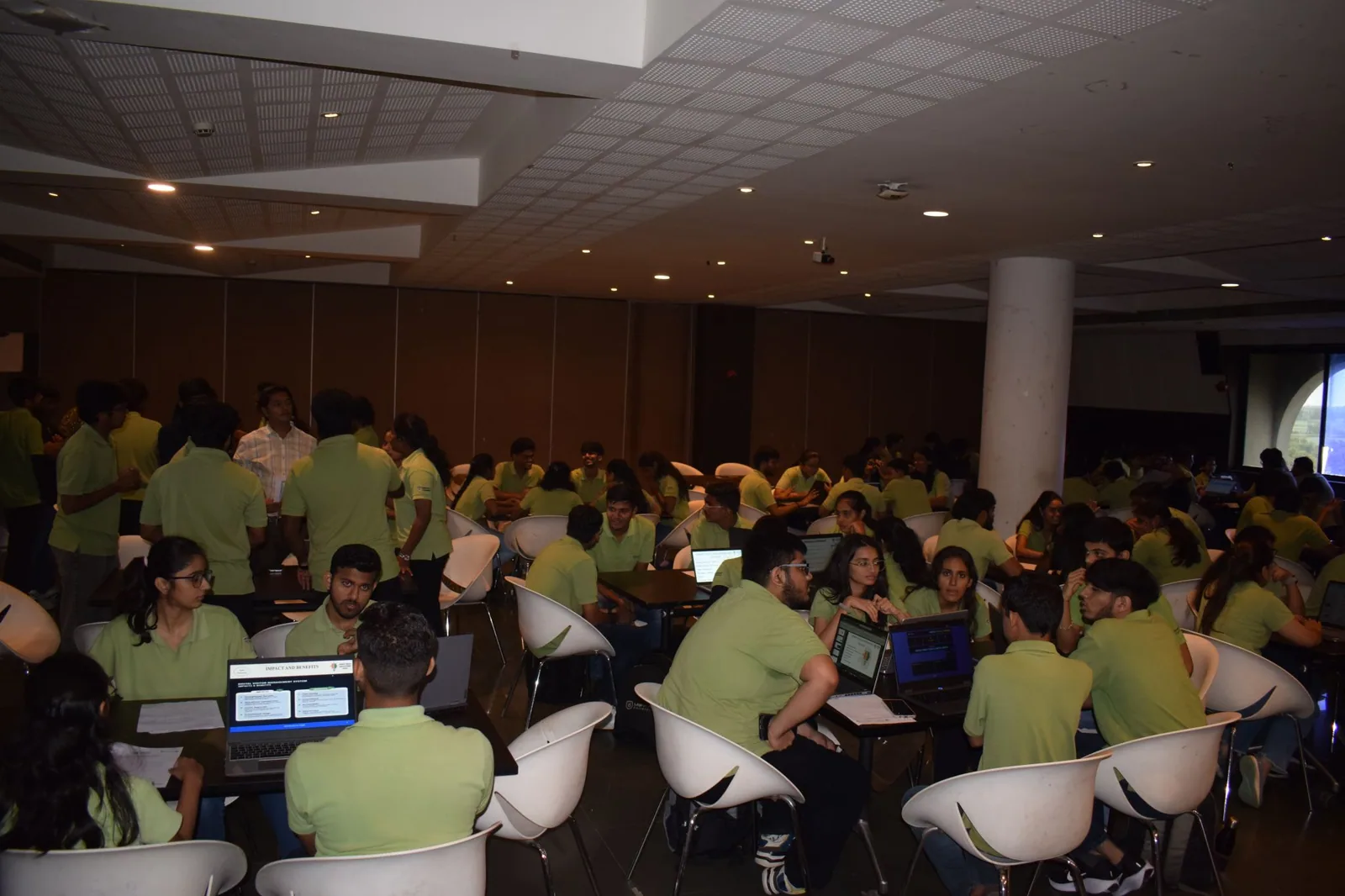 Participants working together in a technology workshop hall